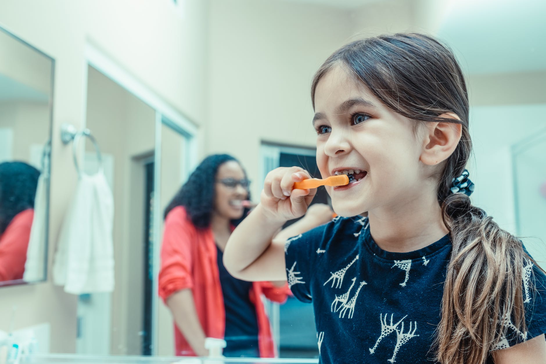 a kid brushing her teeth