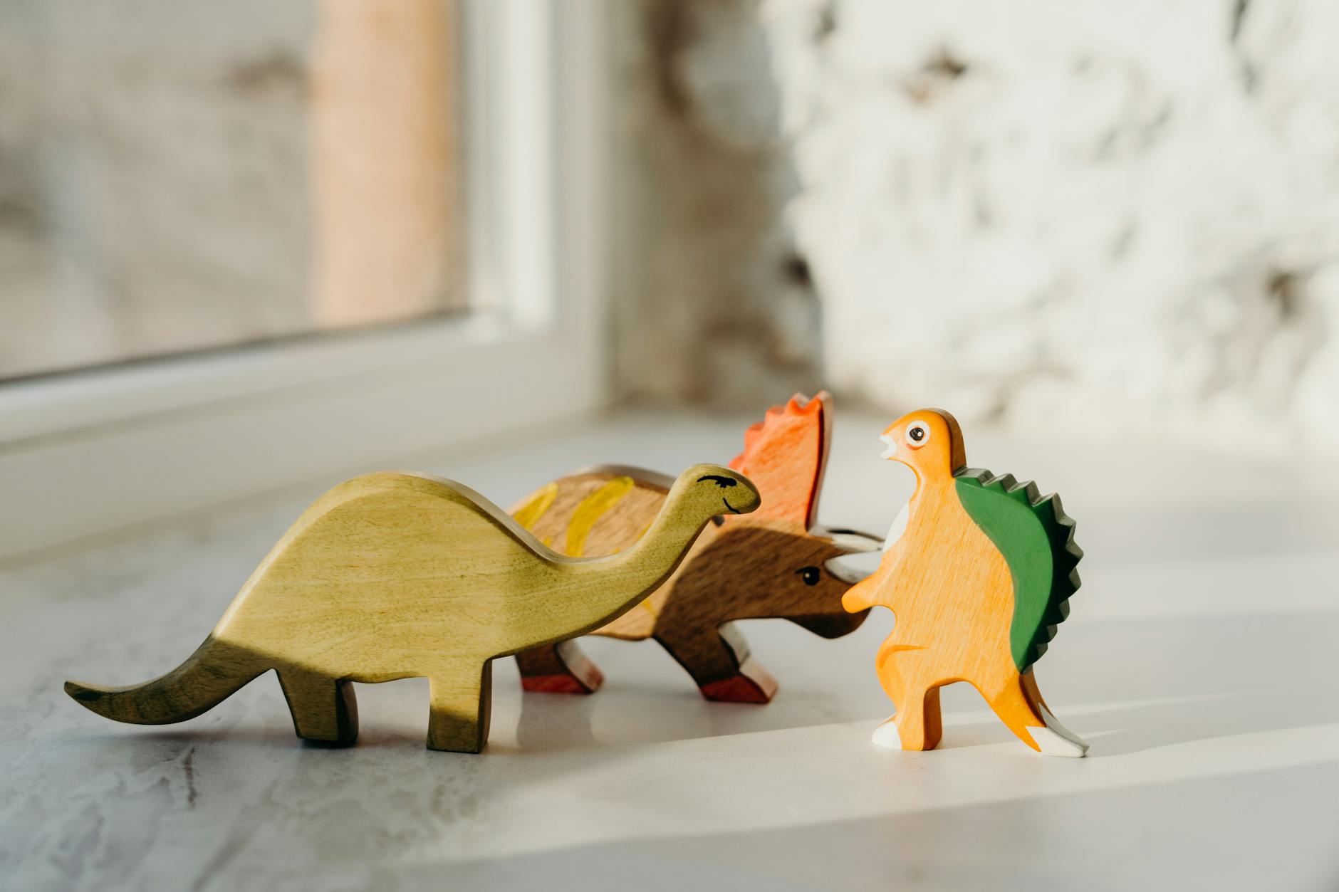 brown wooden animal figurines on white table