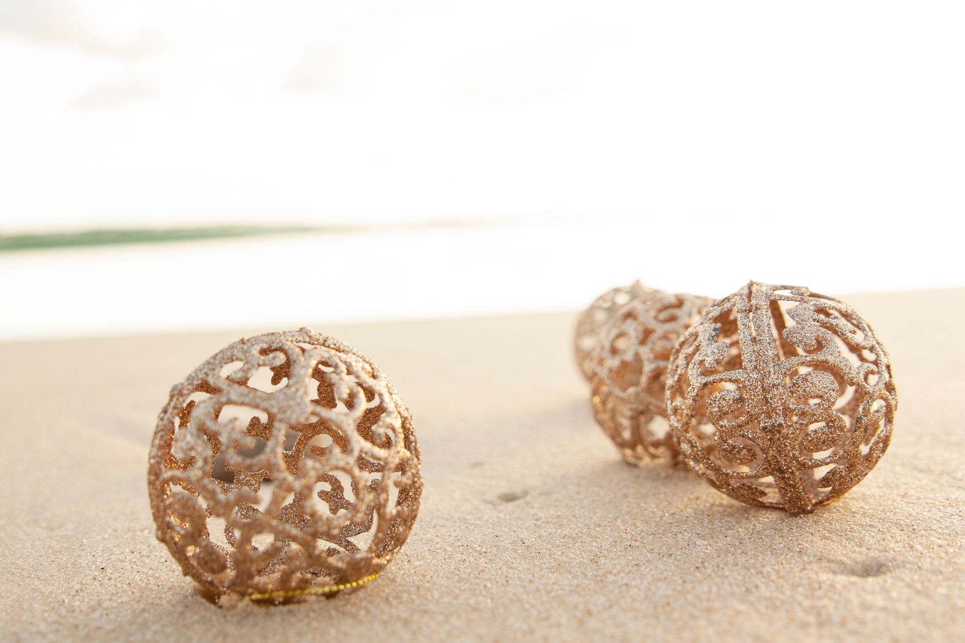 christmas gold ornaments on the sand