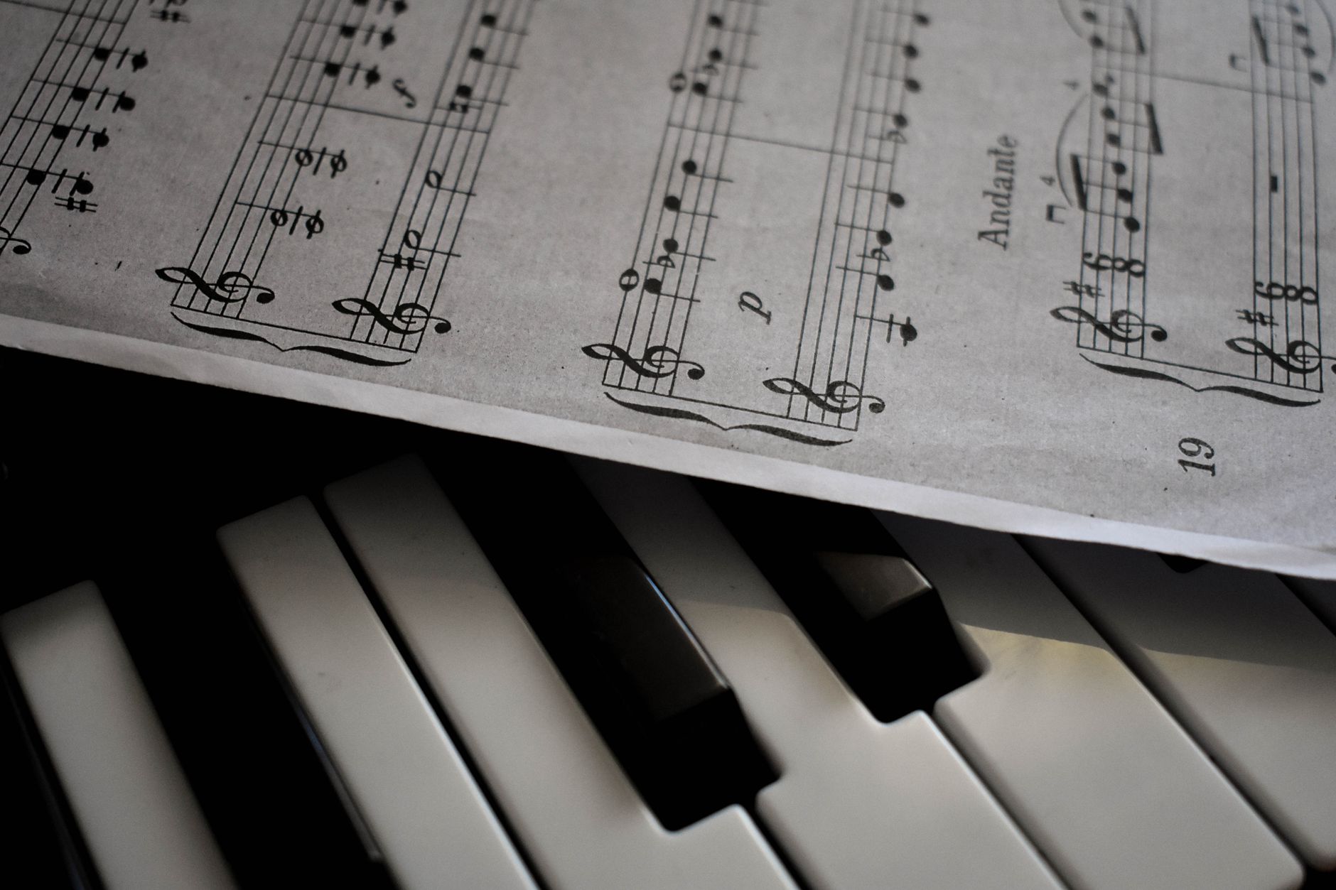 close up shot of musical notes and piano keys