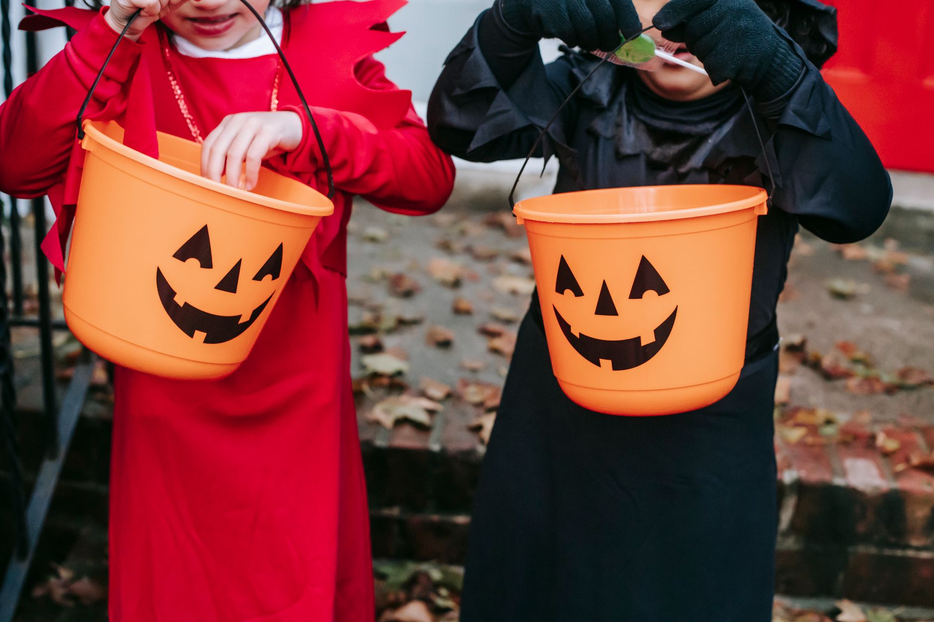 crop kids with halloween buckets for candies