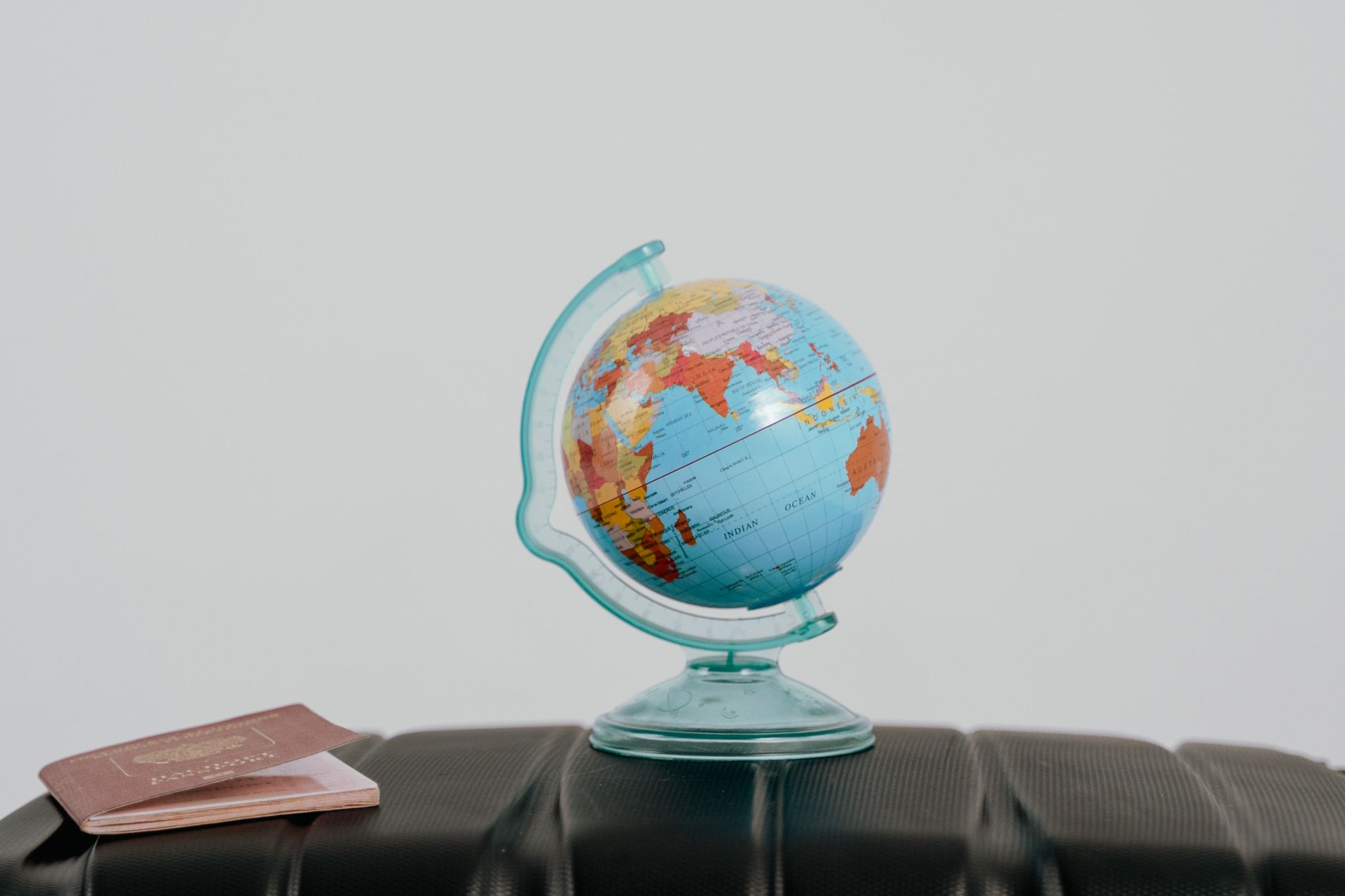 globe beside a passport